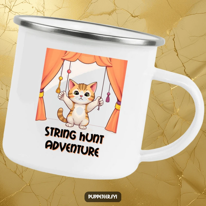 Funny curious cat batting playfully at dangling puppet strings in a colorful theater, enamel camping mug, perfect for enjoying drinks outdoors.