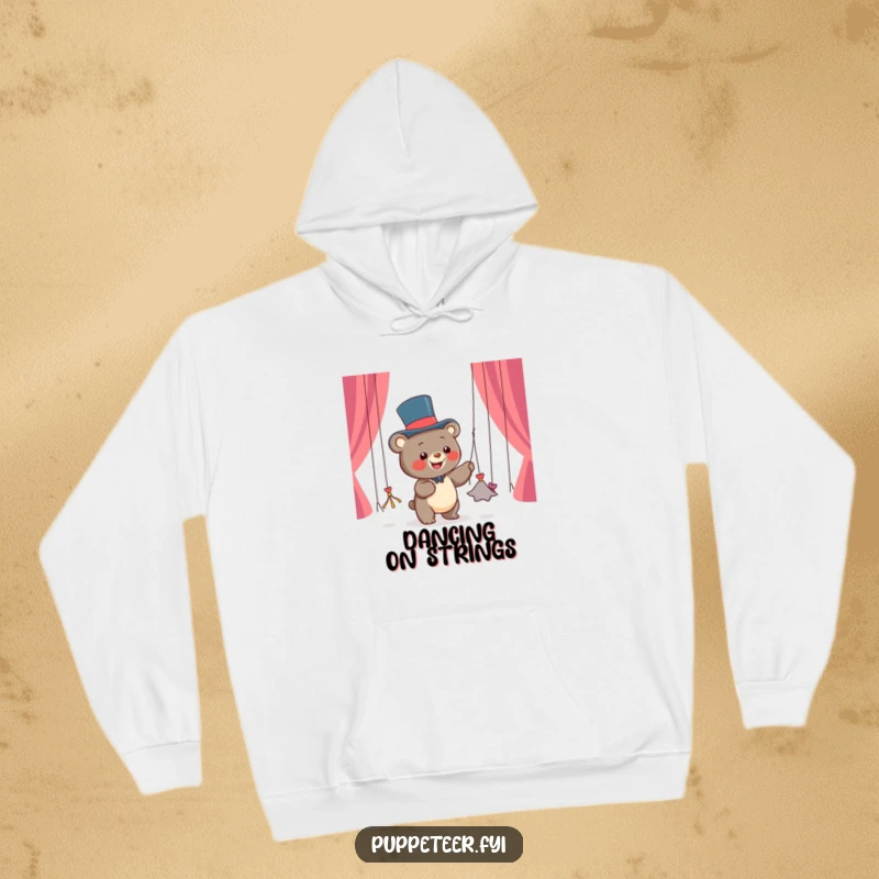Funny hoodie featuring a happy bear cub in a top hat, dancing string puppets emerging from its paws, offering cozy entertainment.