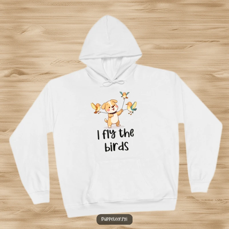 Funny hoodie featuring a playful dog character pulling strings to animate bird puppets flapping their wings, warm and humorous.