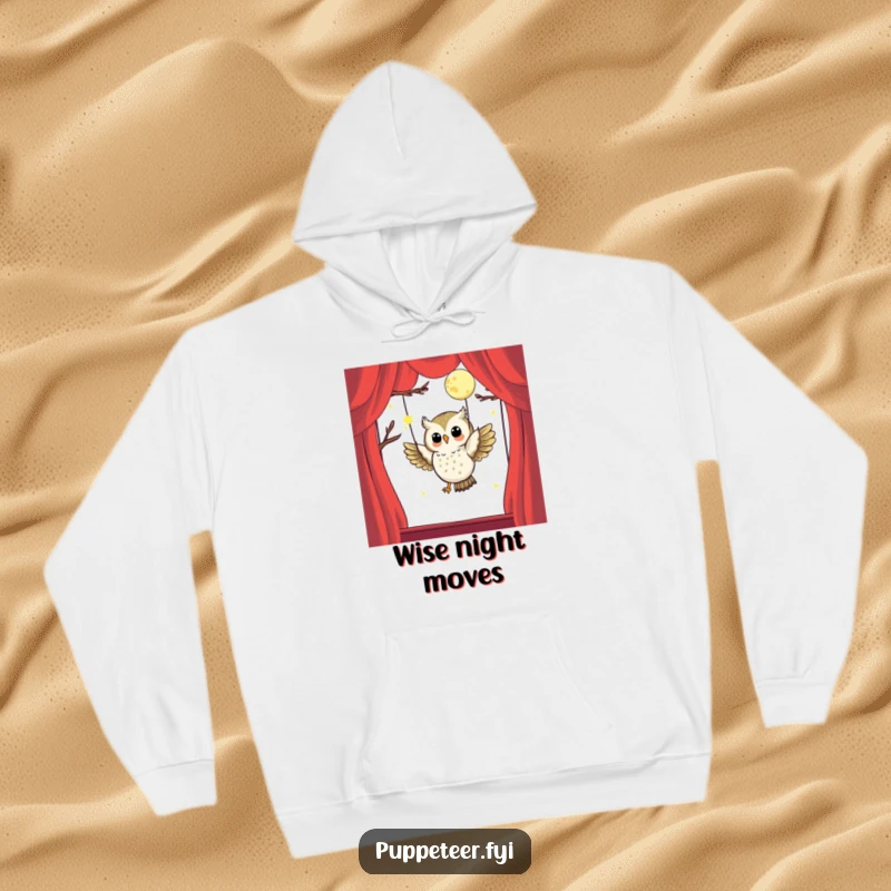 Funny hoodie of a happy owl puppet master masterfully controlling a moon puppet in flight, designed for comfort and imaginative style.