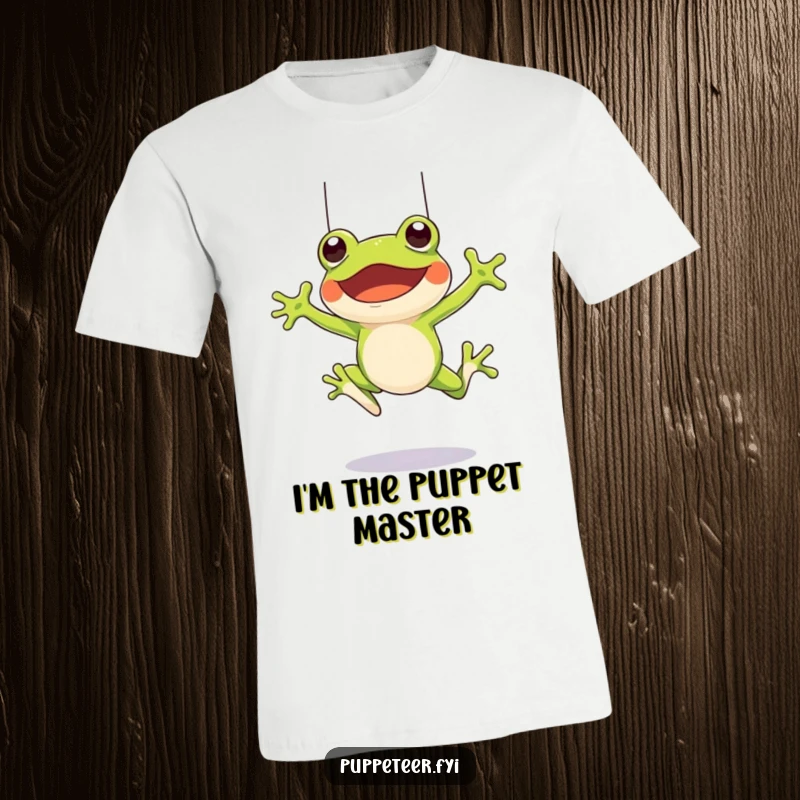 Funny t-shirt depicting a cheerful frog character mid-leap, controlling a frog puppet to jump using strings, embodying pure fun.
