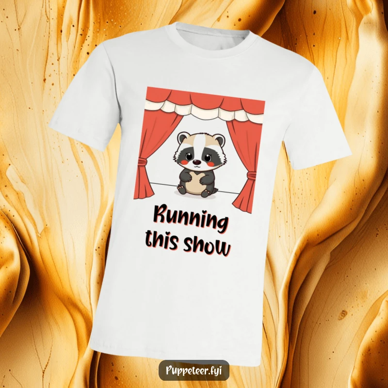 Funny t-shirt featuring a serious badger intently operating a puppet show stage, highlighting dedication and humor.