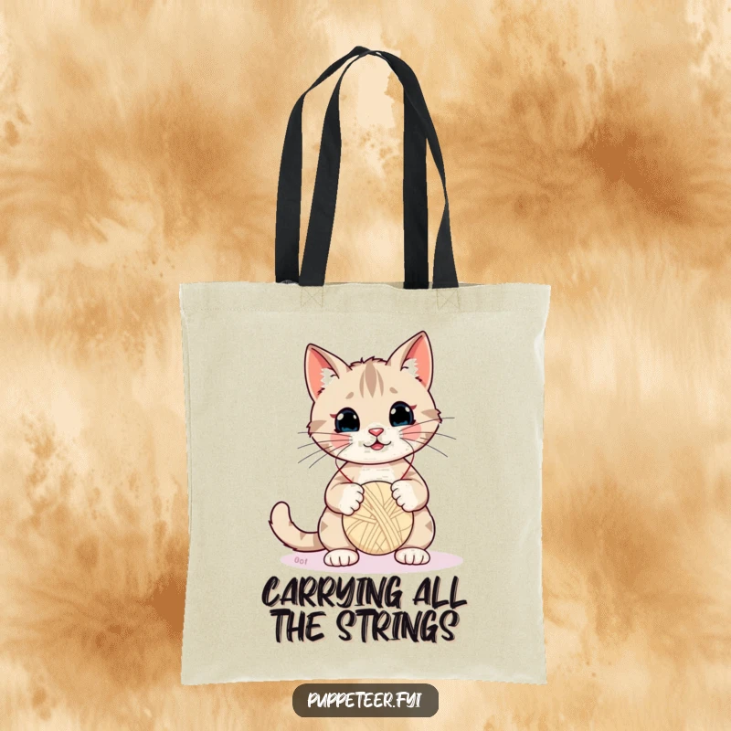 Funny Cat Tote Bag: Adorable cat masterfully controls a yarn ball puppet with strings, highlighting playful mischief and charm.