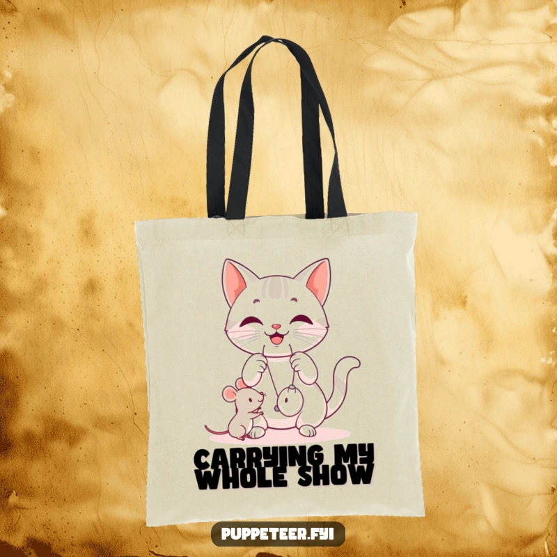 Funny cat tote bag featuring a happy cat manipulating strings, making a small mouse toy jump, perfect for carrying items.