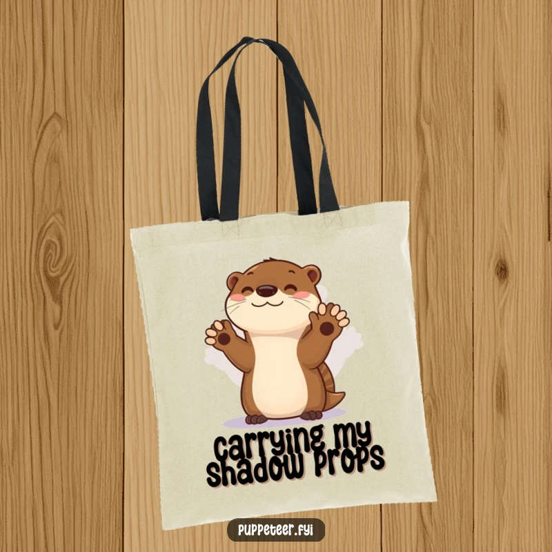 Funny tote bag featuring a talented otter performing a captivating shadow puppet show, perfect for carrying essentials with a smile.